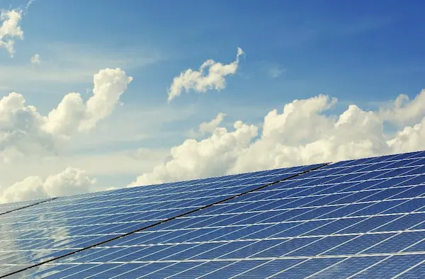 Solar panels set against the backdrop of a blue sky.